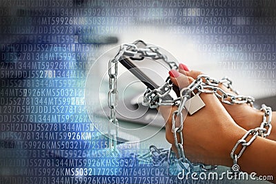 Smartphone addiction concept with womanâ€™s hand trying to break the metallic chain around the phone Stock Photo